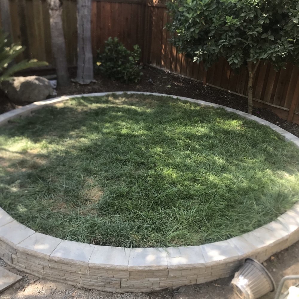 Circular lawn built into a stone retaining ring